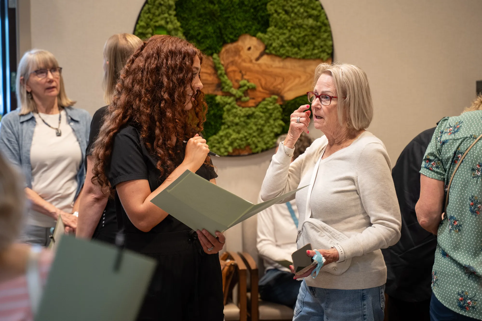 IRIS Aesthetics team speaking with guests at a community event